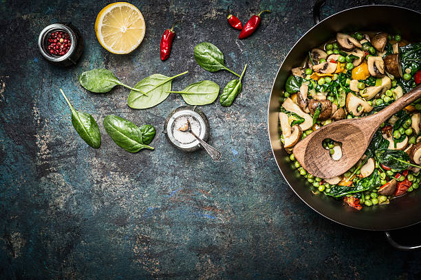 Steamed healthy vegetables in cooking pot with ingredients , top view.