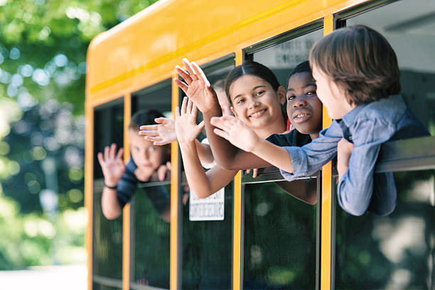 istock School kids hanging out bus windows 585305948