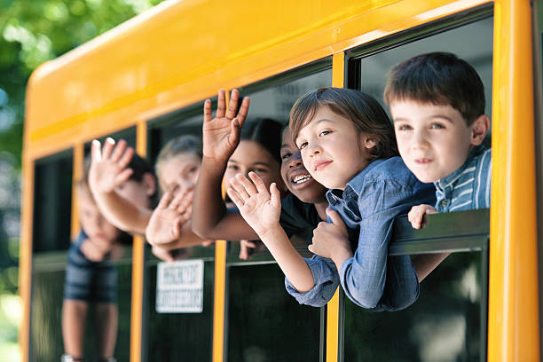 istock School kids hanging out bus windows 585306768