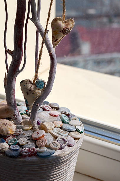 istock tree branch in the pot with buttons 585307596