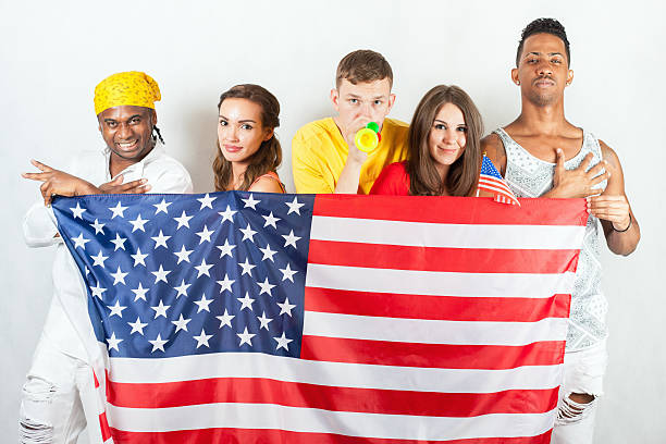 istock Group of multiracial people holding a american flag 585307772