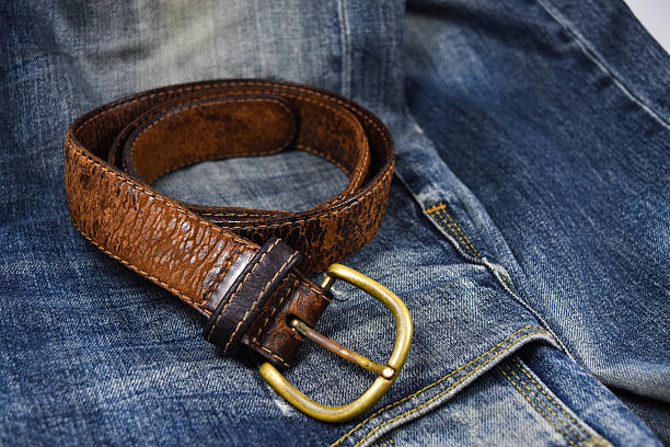 istock leather belt close-up put on Blue jeans 585309130