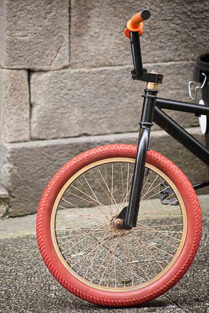 istock Kid's bicycle leaning on a stone wall in the street. 585310112