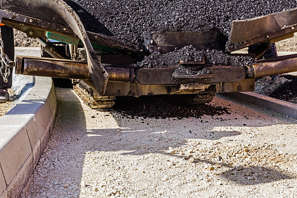 istock Tarmac road laying machine. Asphalt spreader 585310930