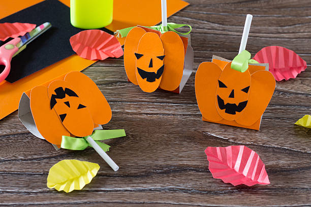 istock The child create a greeting packaging for lollipop on Halloween 585313100