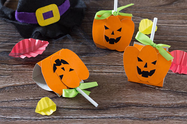 istock The child create a greeting packaging for lollipop on Halloween 585313152