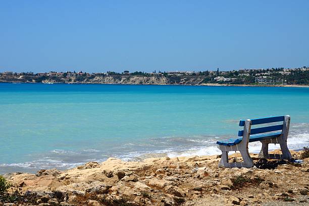 istock Blue Oceanfront Bench in Coral Bay, Cyprus 585315970