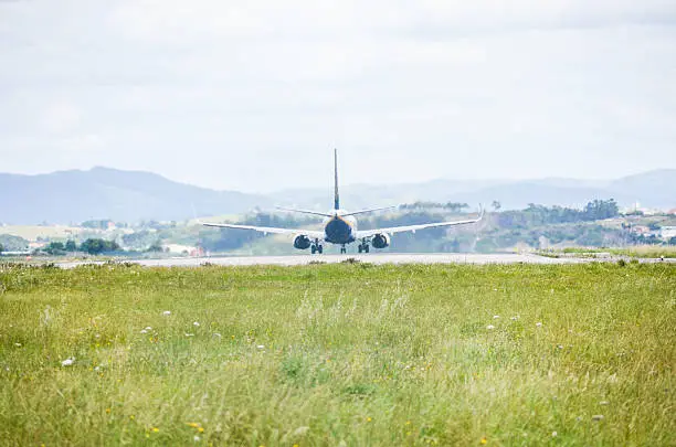 Airplane taking off from Santander airport, in Spain. This picture was taken from outside the airport land.