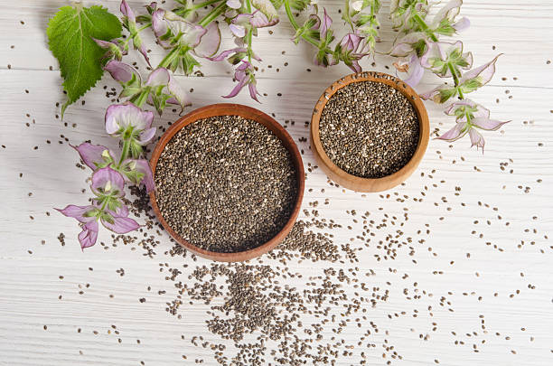 Chia seed healthy super food with flower. Salvia hispanica. Chia seed healthy super food with flower over white wood background. Salvia hispanica. salvia hispanica plant stock pictures, royalty-free photos & images