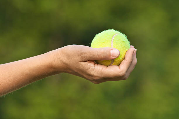 istock tennis ball in hand 585319182