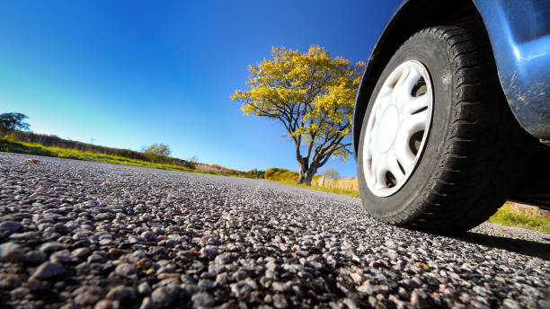 istock Car on asphalt road in autumnal evening 585319330
