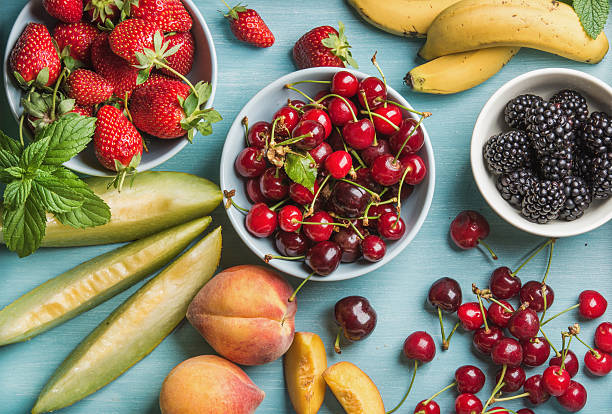 istock Healthy summer fruit variety on blue wooden backdrop 585320104
