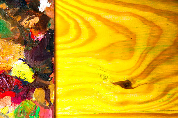 istock Painting palette on colored wooden background 585320544