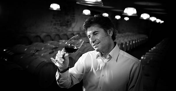 istock Portrait confidant vintner drinking red wine in winery cellar 585322242