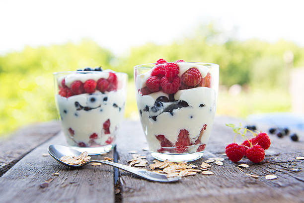 istock Layered dessert with cream cheese, raspberry, currants and homemade granola. 585323714