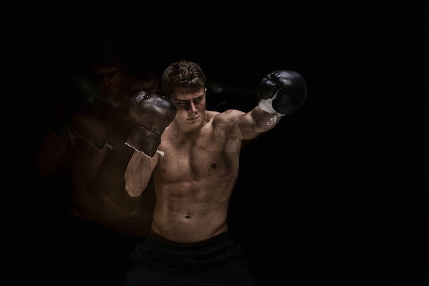 istock Shirtless muscular boxer punching 585325124