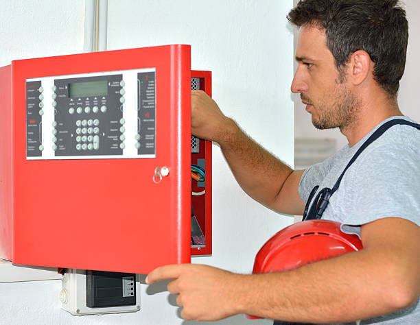 Electrician with Protective Workwear and Hard Hat at Work