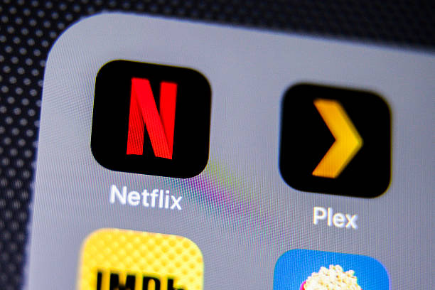 Netflix App Icon on iPhone La Habra, United States - August 2, 2016: Macro closeup image of Netflix app icon among other icons on an iphone smartphone device.  brand name games console stock pictures, royalty-free photos & images