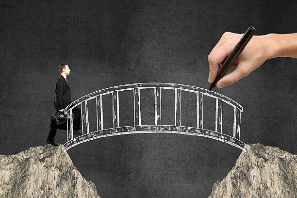 istock Businessman walking across bridge 585328572