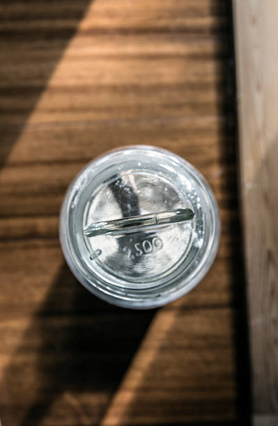 istock wooden spoon into a fluor glass jar 585328642