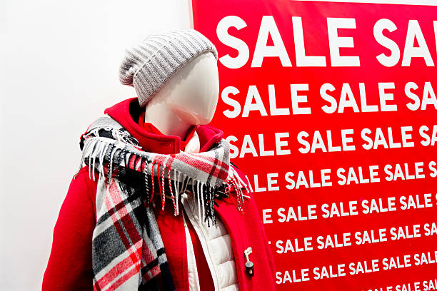 Large group of sale signs on a clothes store.