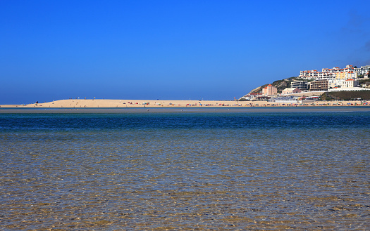 Portugal, Caldas de Rainha, Lagoa de Obidos or Obidos Lagoon with the holiday town of Foz do Arelho in the background. Crystal clear water at low tide.