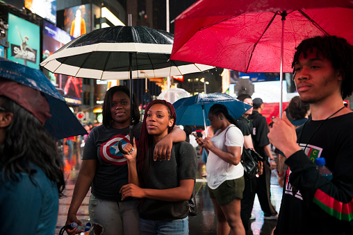 New York City, USA - July 9, 2016: People listen to a speaker (not pictured) at a Black Lives Matter protest in Times Square in New York City.