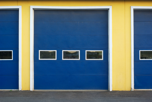 garage doors blue and yellow front of commercial building