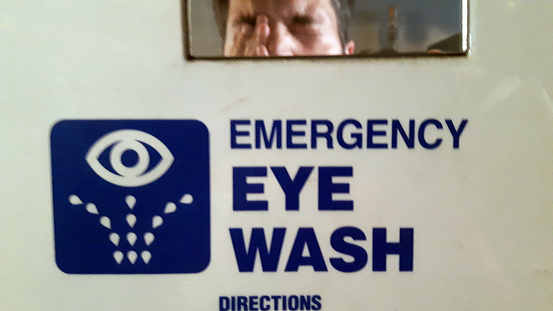 Injured worker standing in fron tof Emergency Eye Wash Station