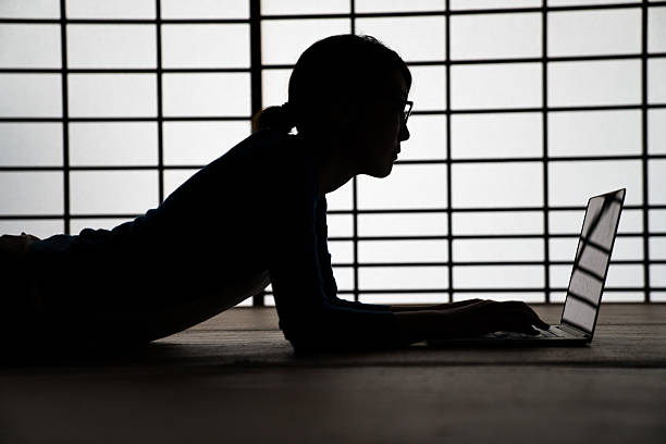 Woman using a laptop computer in a Japanese temple