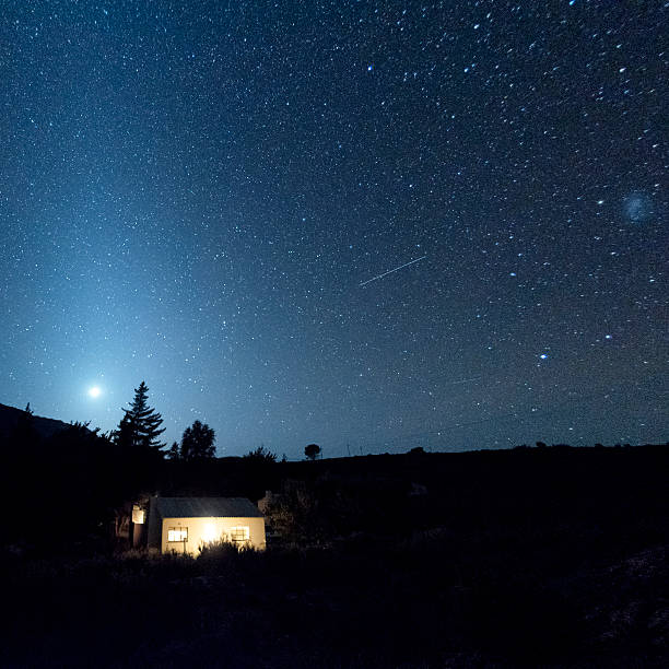 country cottage with sky at night - uydu çanağı fotoğraflar stok fotoğraflar ve resimler