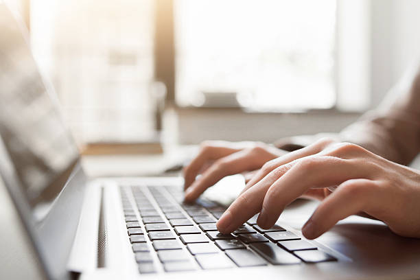 Typing on laptop closeup, chatting in Facebook Typing on laptop closeup, chatting in Facebook, meeting website. Blogger, journalist writing new article. contented emotion stock pictures, royalty-free photos & images