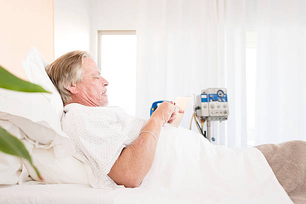 istock Senior Man In Hospital Bed 585488834