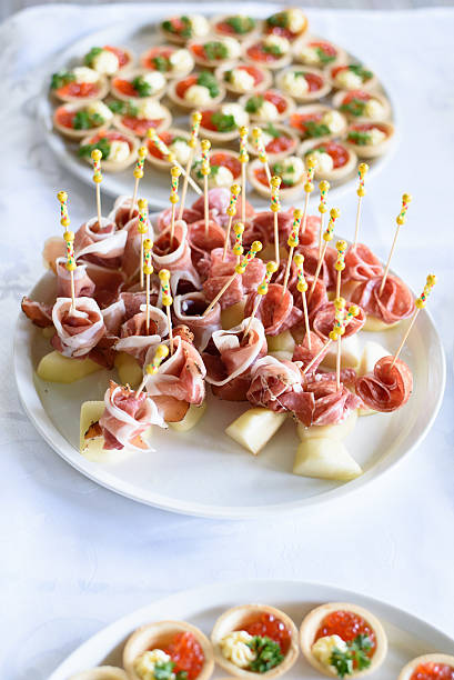 Italian prosciutto ,raw ham leg sliced on white plate
