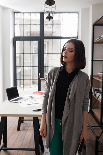 istock Attractive business woman, standing in office 585489062