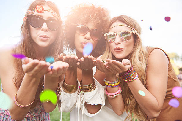 Girls blowing some confetti pieces