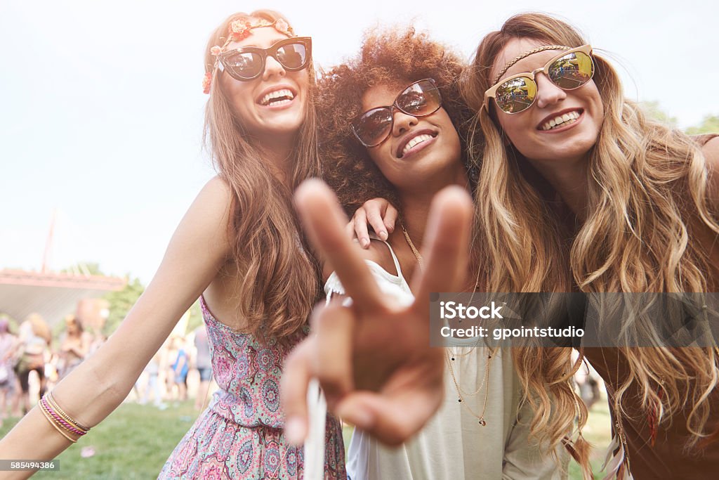 Peace sign and three friends Music Festival Stock Photo