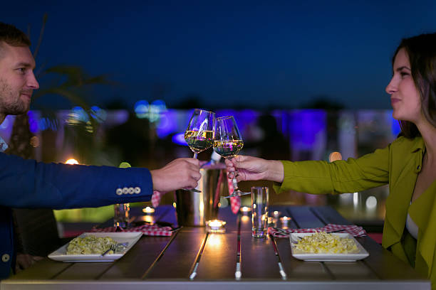 istock Couple wine toasting in restaurant 585497416
