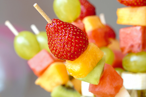 Fruit skewers on the table                            