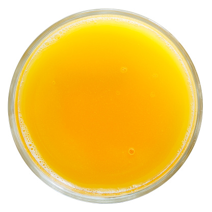 Glass of orange juice isolated on white from above.