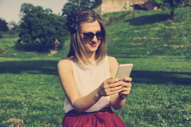 istock Woman using cellphone outdoors. 585499342