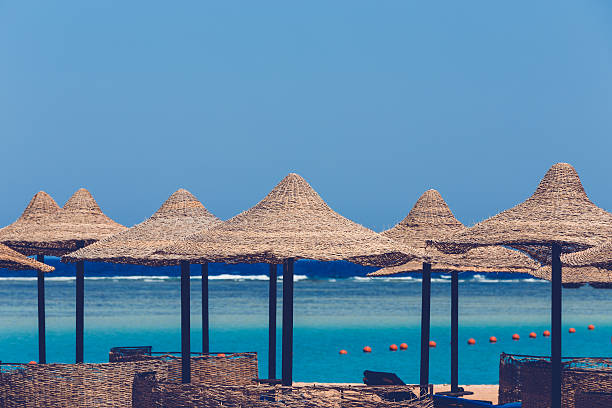 istock Beach umbrellas and blue sky background 585500754