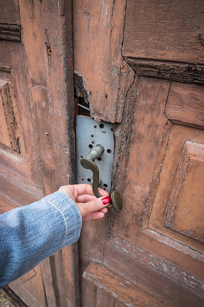 istock Female hand and old door 585501254