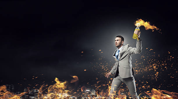 istock Businessman throwing petrol bomb . Mixed media 585501498