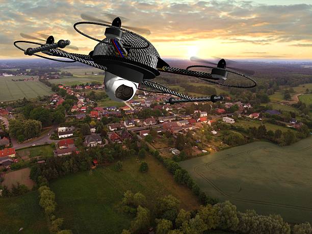 istock drone quadrocopter with camera in flight over over suburban Houses 585502186