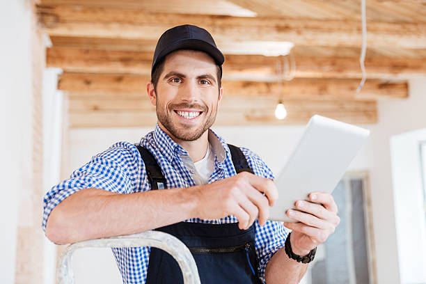 istock Close-up portrait of a builder holding pc tablet computer 585502246