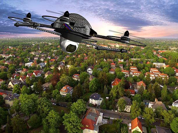 istock drone quadrocopter with camera in flight over over suburban Houses 585502436
