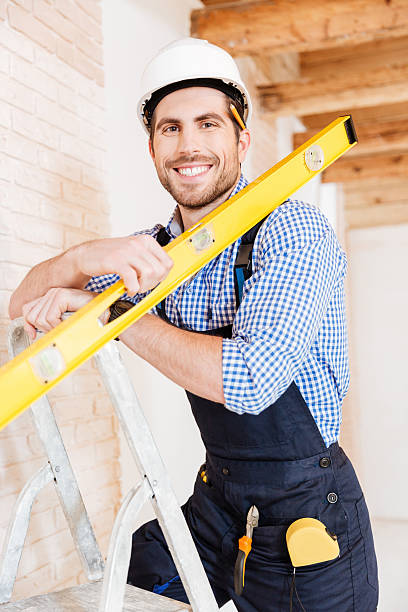 istock Close-up portrait of a working man with level 585503160