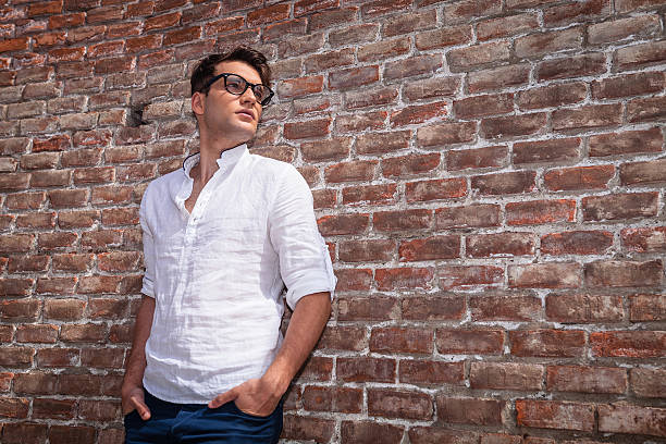 istock Young casual man holding his hands in pockets 585504760