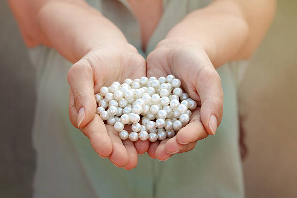 istock Woman holding pearl 585505830